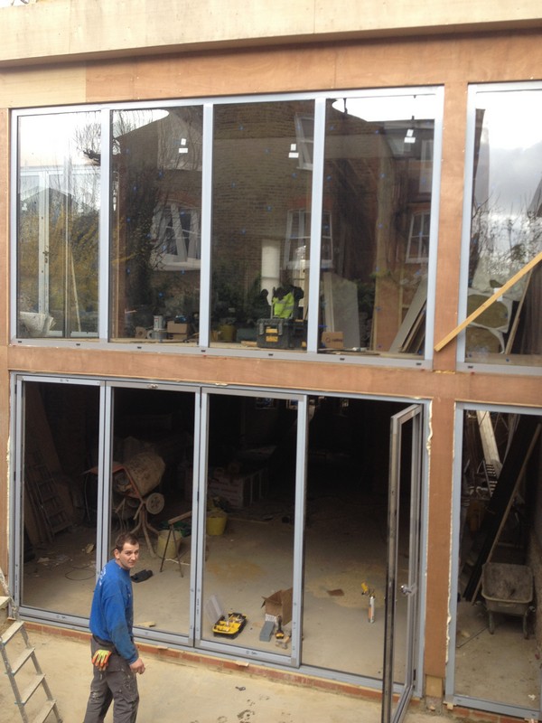 Aluminium bi-fold doors with two-storey glazing in Acton