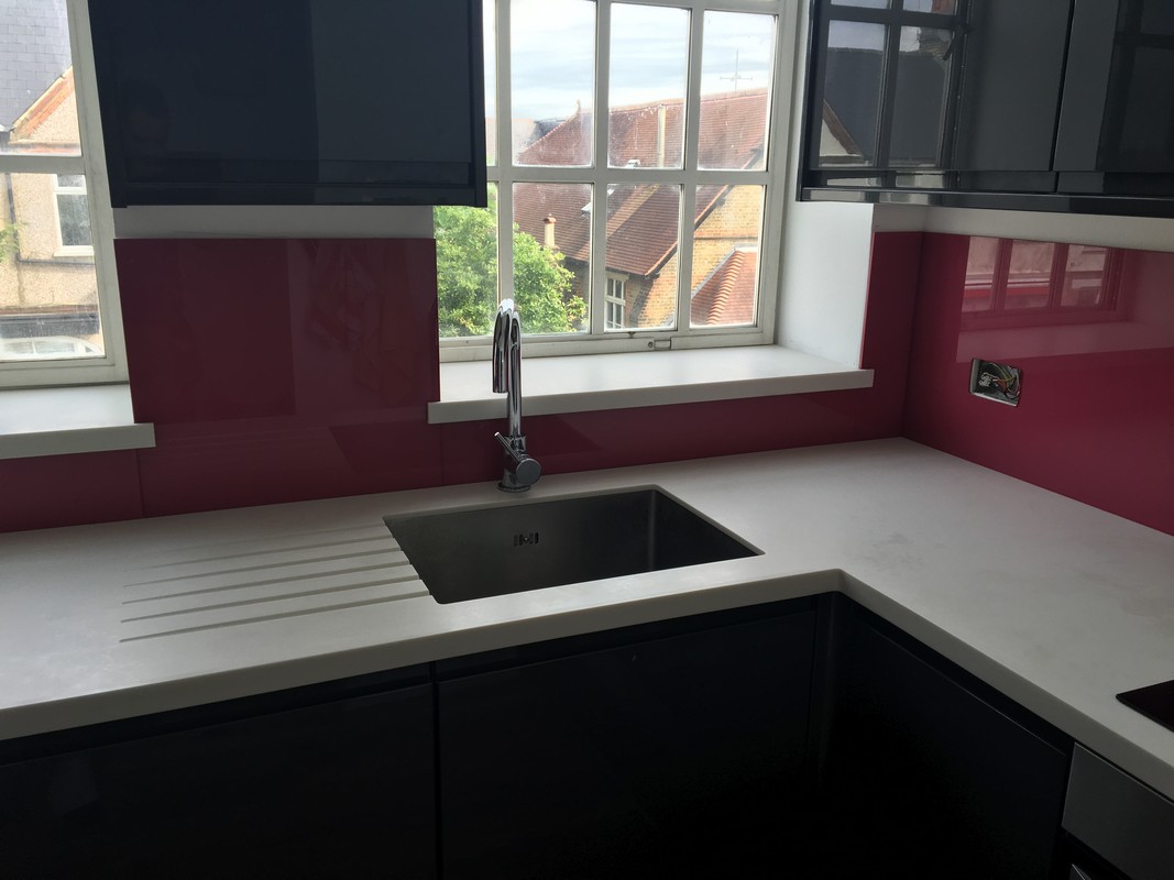 Deep plum coloured glass splashback in modern Acton kitchen