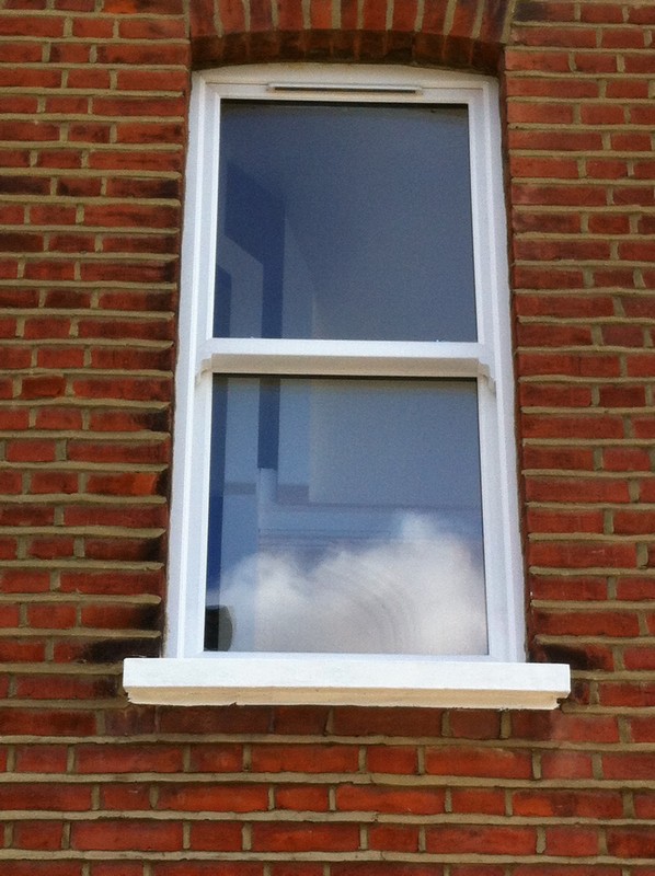 uPVC sash window on Victorian red brick house in Acton